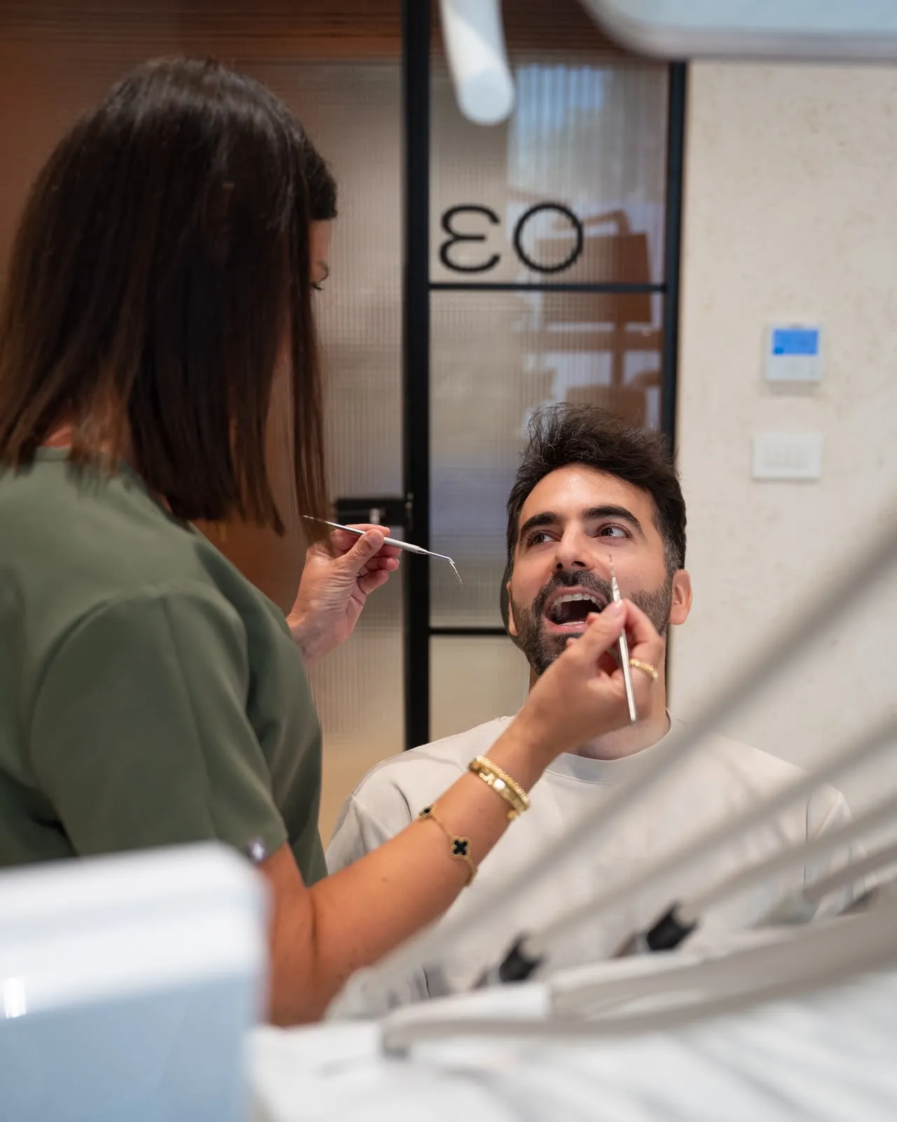 A dentist examining a patient in a DC360 treatment room