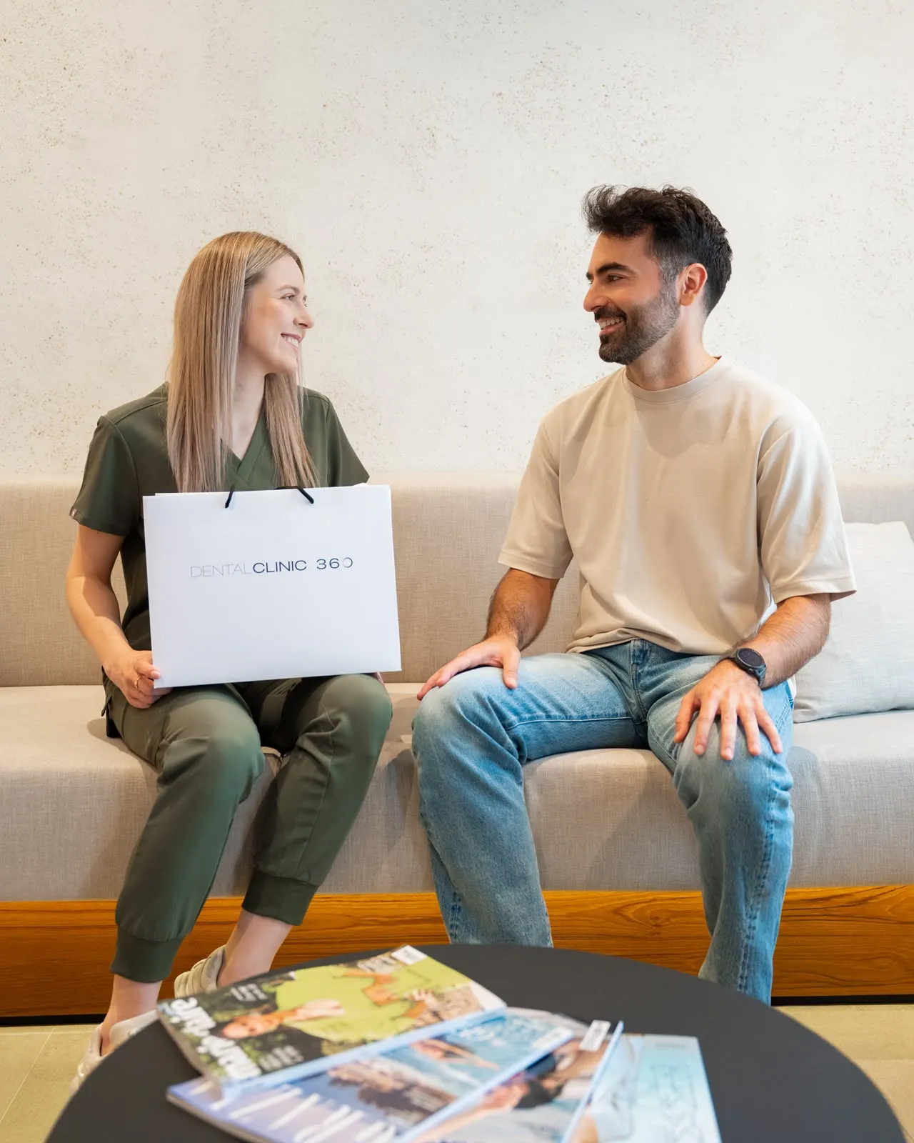A dentist and patient talking on the sofa at DC360