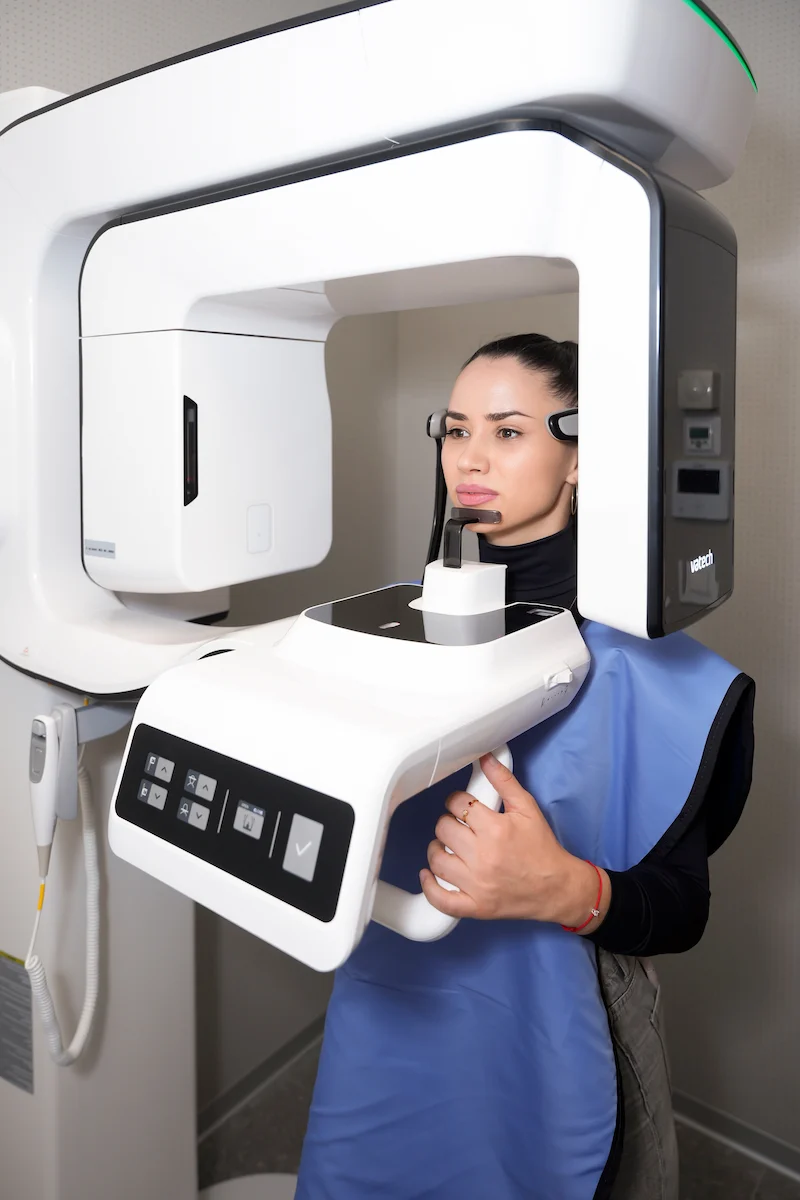 A patient having a panoramic X-ray taken